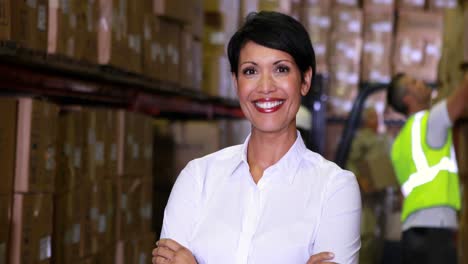 Warehouse-manager-smiling-at-camera