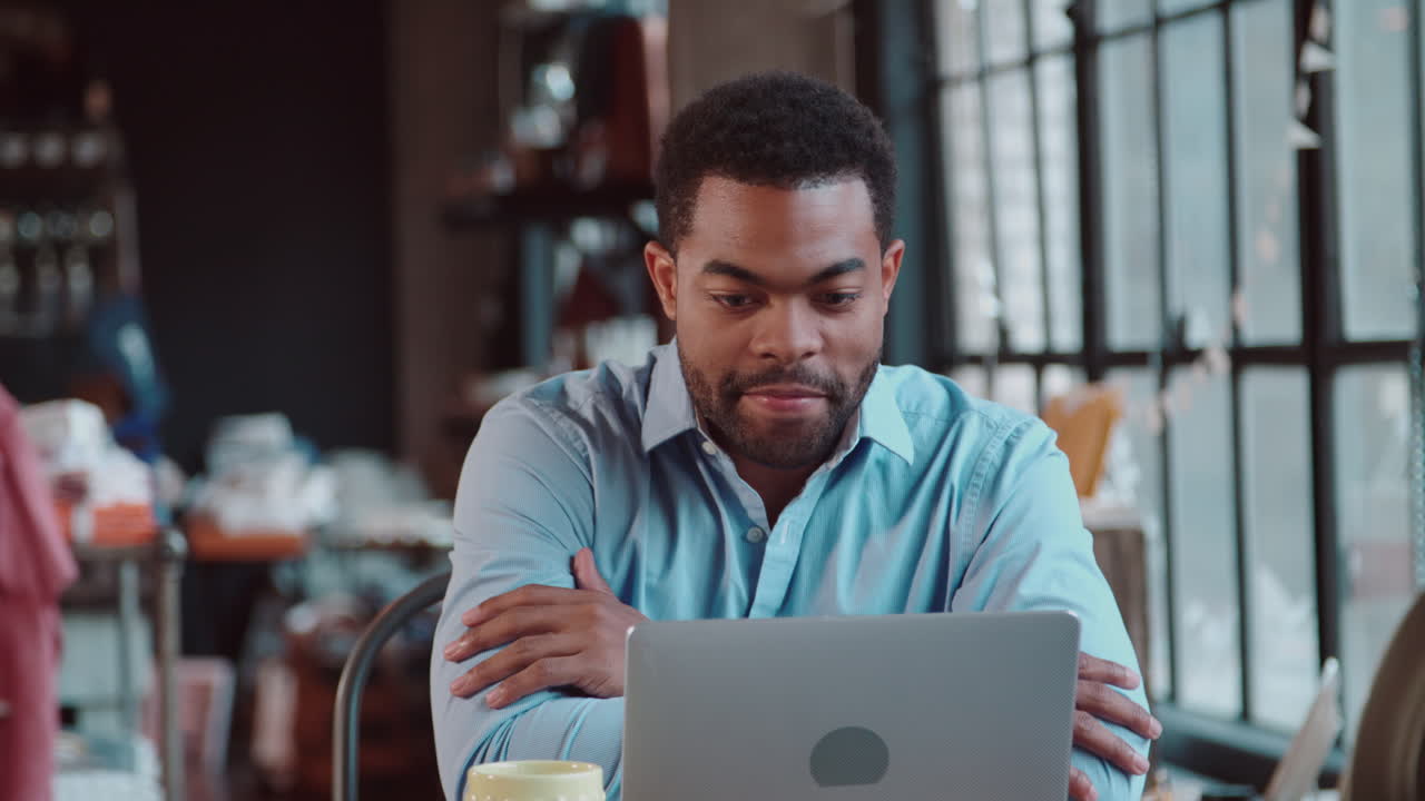 Businessman Using Laptop At Desk In Busy Office Shot On R3D