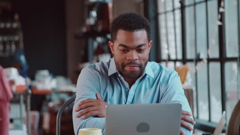 businessman using laptop at desk in busy office shot on r3d