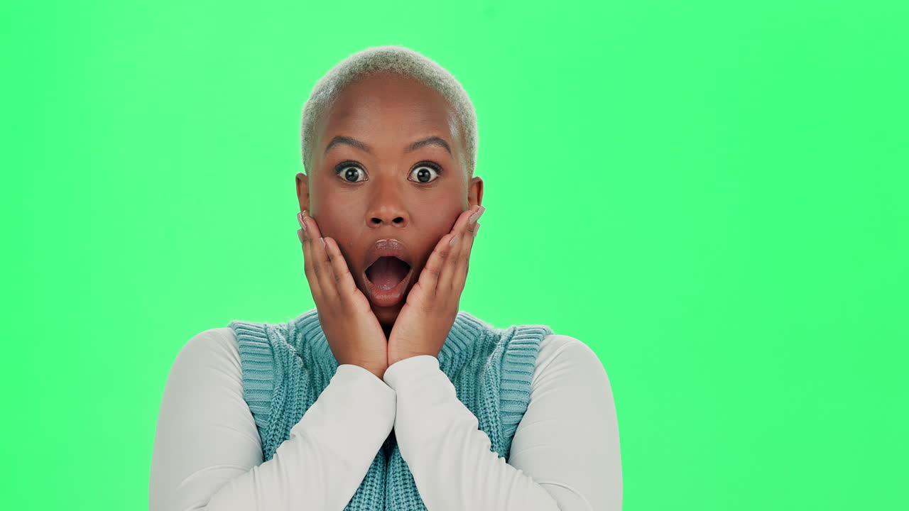 Surprised African American Woman with Open Mouth on Green Background