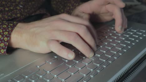 hands typing at a laptop keyboard