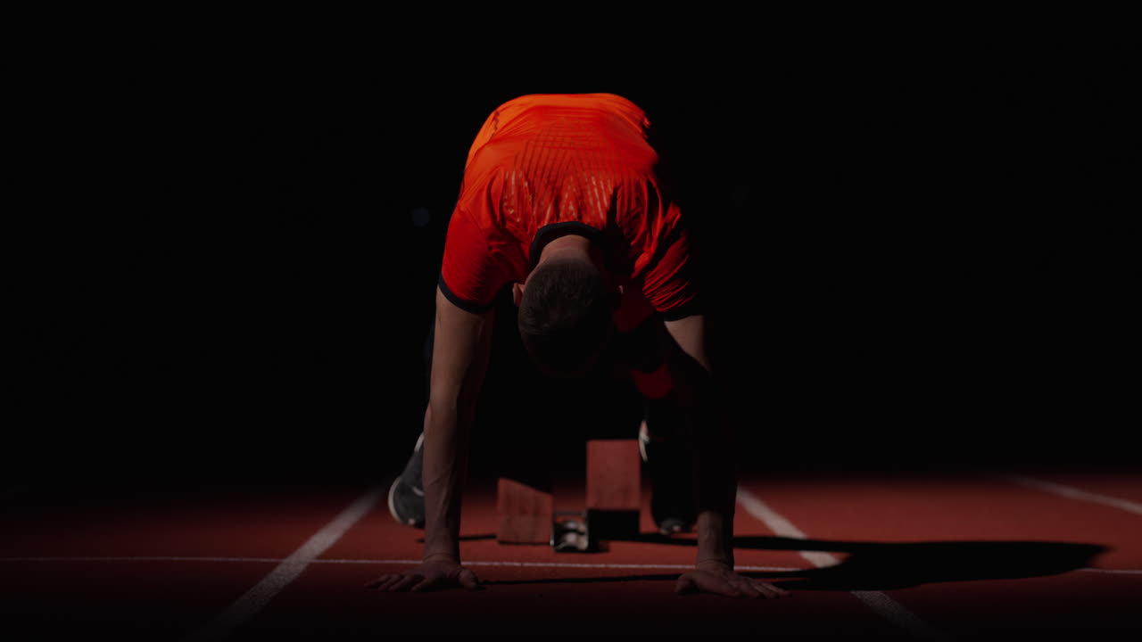 Athlete preparing for a race at night on a track