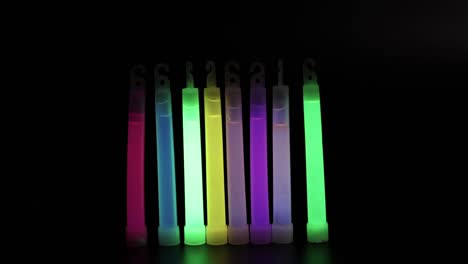 hand moving glow sticks in the dark