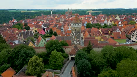 4k aerial drone video of the historic röderturm tower and gate of the walled city of rothenburg ob der tauber, germany