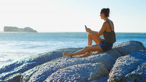 Female-volleyball-player-using-mobile-phone-4k