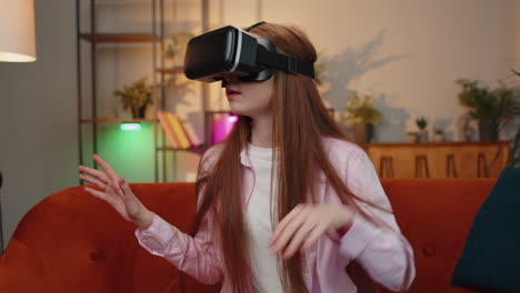 Child-girl-using-virtual-reality-futuristic-technology-headset-play-simulation-3D-video-game-at-home