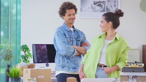 Portrait-Of-Couple-Running-Online-Business-From-Home-Packing-Boutique-Candles-Ready-For-Shipping