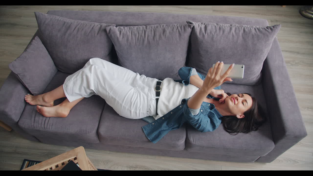Woman Taking Selfie on Couch