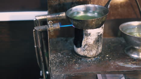 jeweler-installs-gas-burner-to-heat-liquid-in-shop-closeup