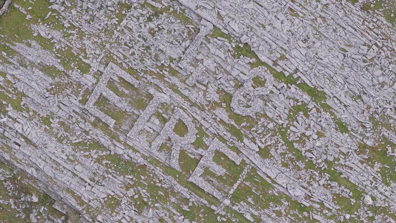 48 eire sign made of rocks on irish road, burren, wild atlantic way, aerial view