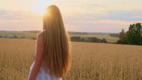 woman in a field at sunset