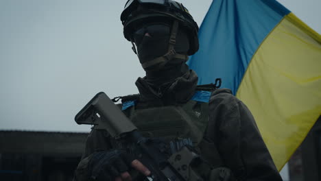 ukrainian soldier in uniform with weapon and flag