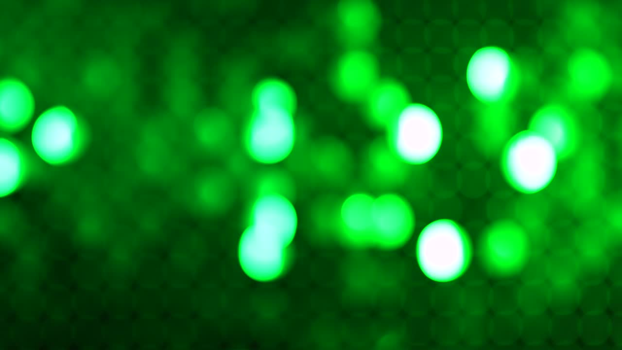 Blurred green background with shining, shimmering lights. Excellent for text savers or CG. Concept of holiday, celebration or glamour party