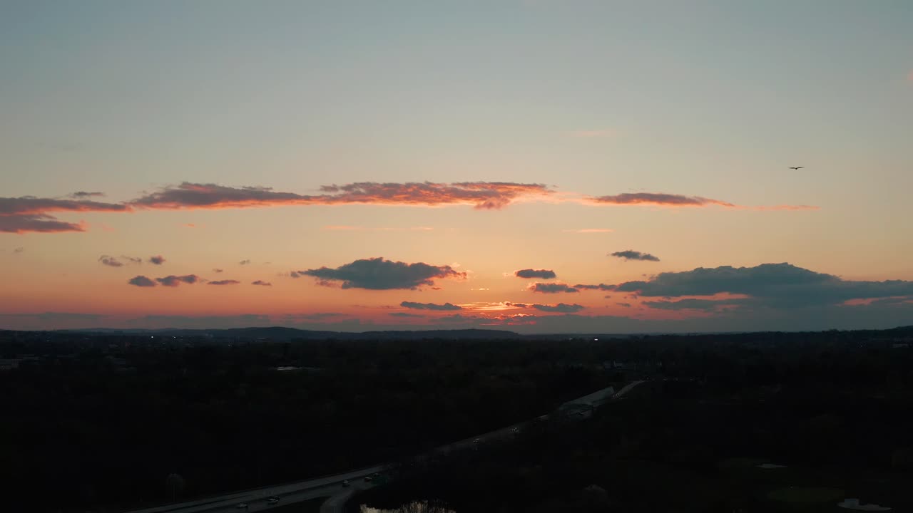 Aerial of sunset as birds fly through shot of heaven