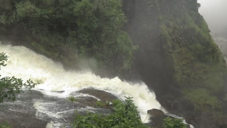 top of victoria falls in rain season, waterfall is full of water, everywhere is mist