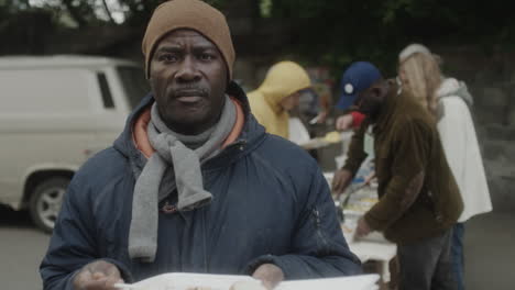 man receiving food at a charity distribution event