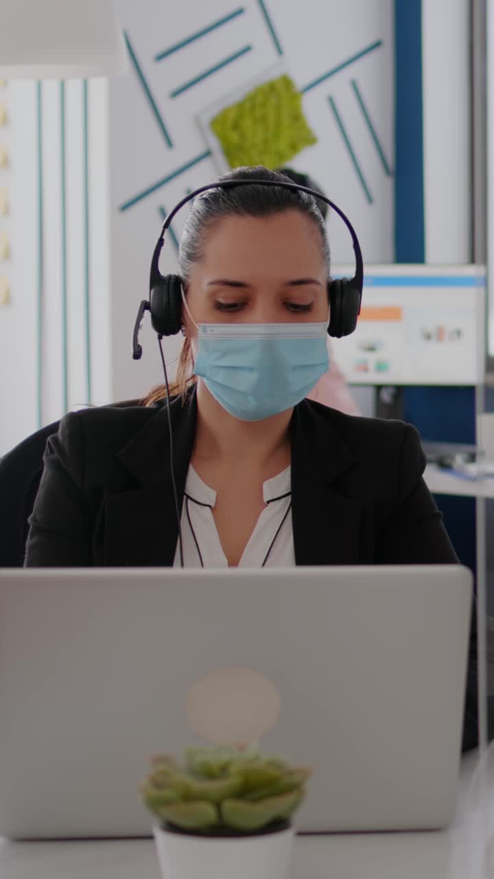 Businesswoman working with mask in the office