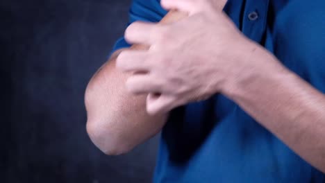 person itching their elbow