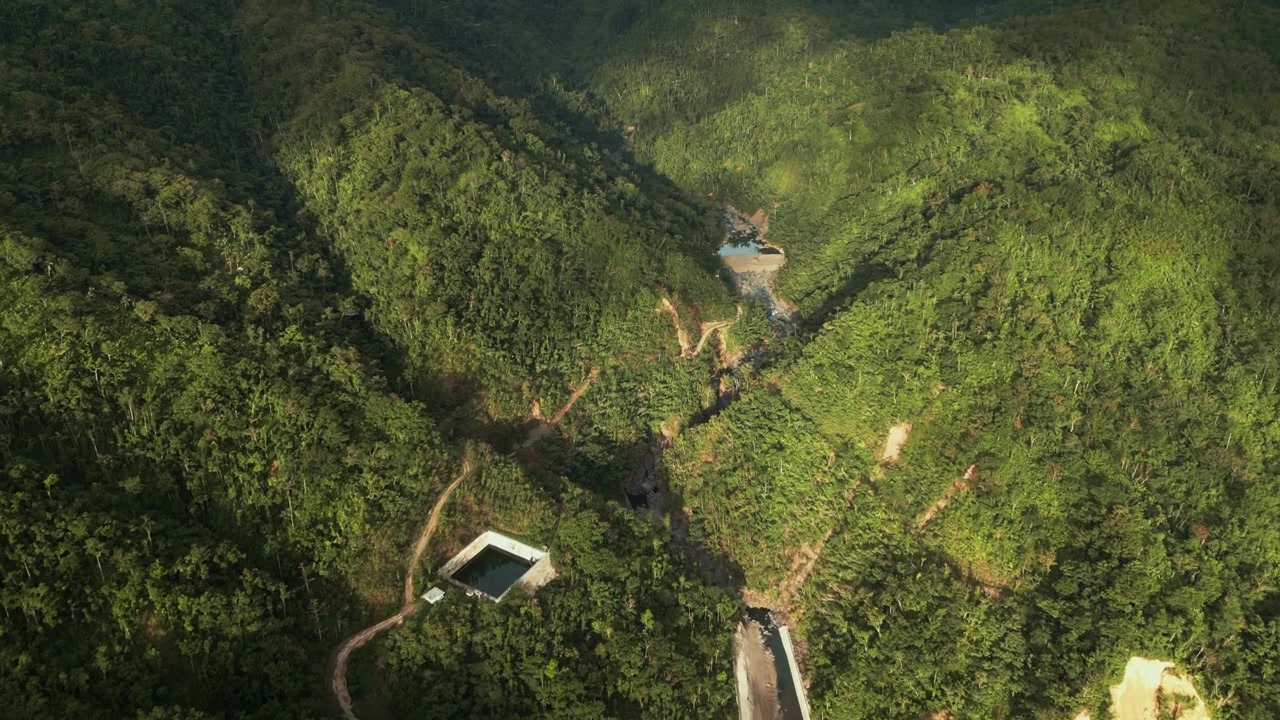 Obi, Caramoran, Catanduanes, Philippines - A Scenic View of Lush Green Hills, Winding Paths, and a Peaceful Mountain Landscape - Aerial Drone Shot
