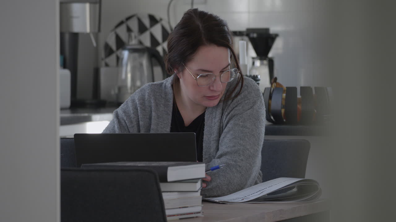 Focused adult woman studying at home