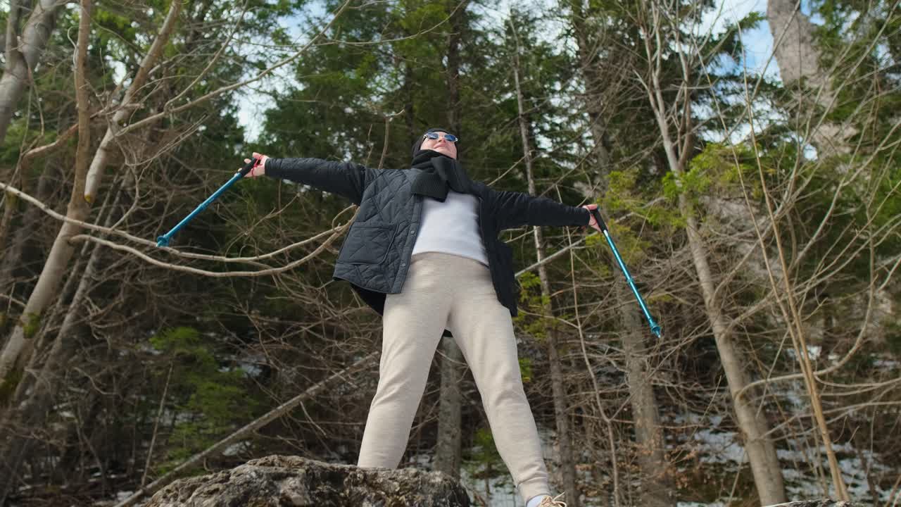 Woman Hiking in a Snowy Forest