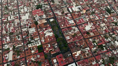 DRONE:-HIGH-ALTITUDE-ORBIT-OF-DOWNTOWN-URUAPAN-MICHOACAN-AT-SUNSET