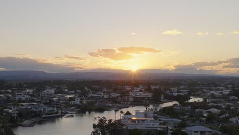 drone captures serene sunset over gold coast canals, highlighting tranquil waters and vibrant skies with a warm, peaceful ambiance