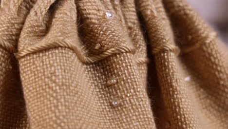 close-up of woven fabric with decorative embellishments