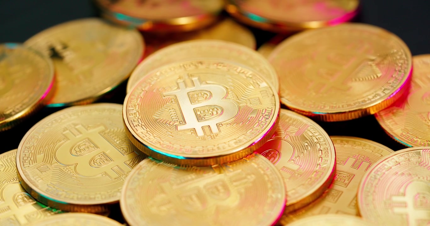 Monete d'oro di criptovaluta Bitcoin con riflessi scintillanti
