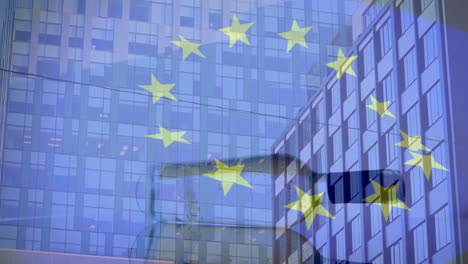 animation of flag of eu and spinning bottle over modern office buildings