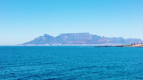 departing robben island by boat towards cape town, with table mountain in the background