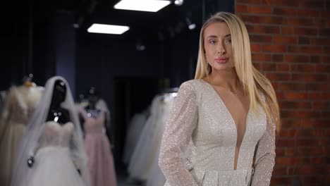 a model elegantly showcases a chic bridal gown, beautifully set amidst a variety of elegant wedding dresses