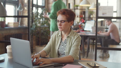 woman working on laptop in open office