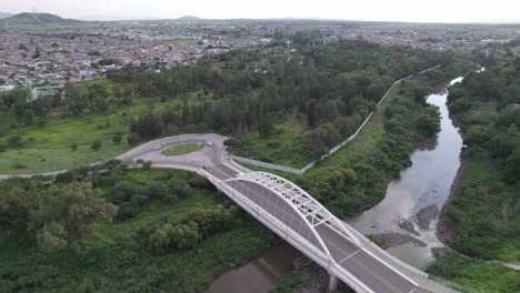 a-bridge-with-traffic-in-the-city-and-a-river