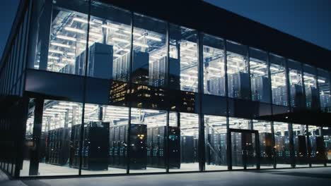 this modern data center showcases its sleek, illuminated structure amid the vibrant urban skyline. bright lights highlight the technology inside as dusk falls, creating an impressive view.