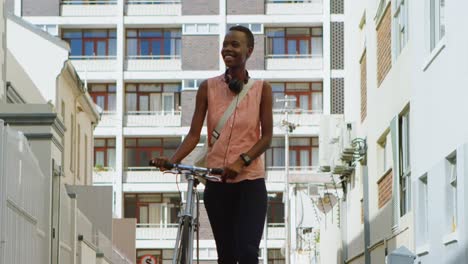 woman walking with bicycle in the city 4k