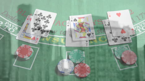 animation of playing cards and chips on board over cityscape