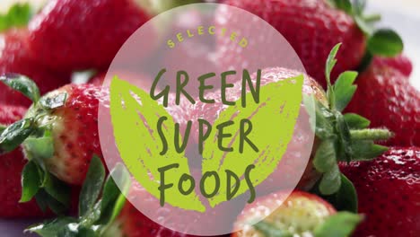 green super foods text banner against close up of strawberries