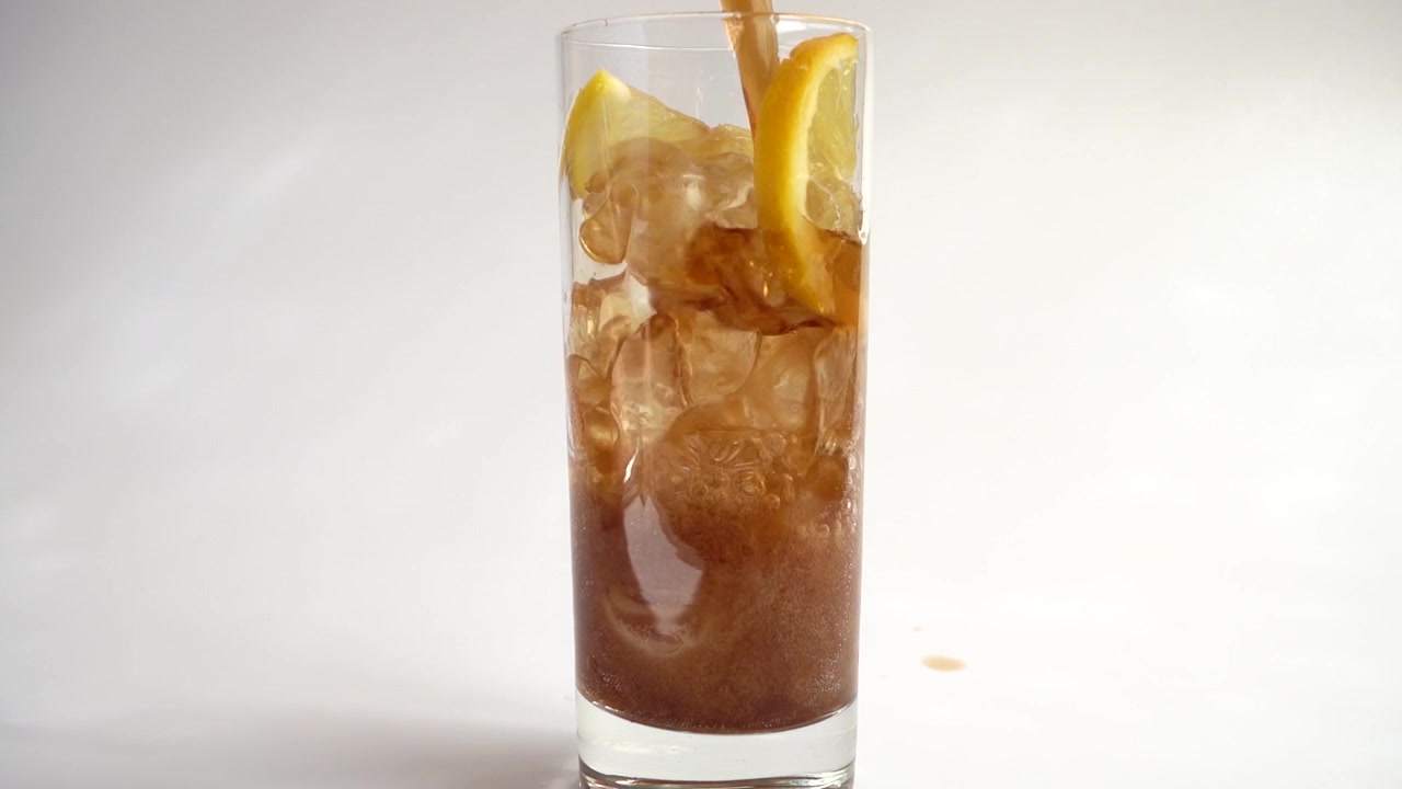 Preparazione di Coca Cola con ghiaccio e limone. Slow motion