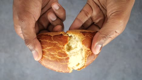 hands holding a piece of bread