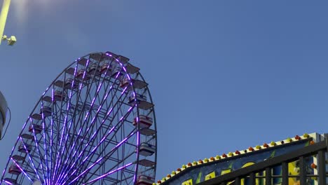 carnival ferris wheel early morning late evening light with flashing lights