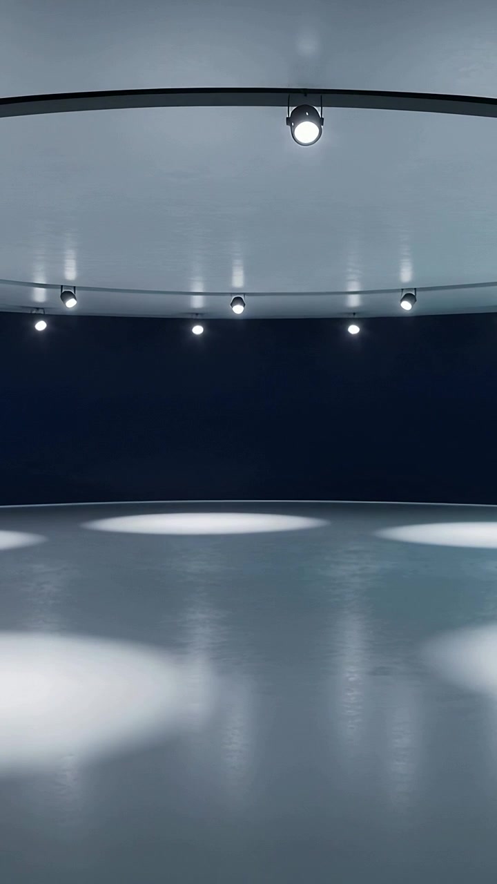 Vertical video: Cue lighting track lights moving spots on glossy floor and wall for show