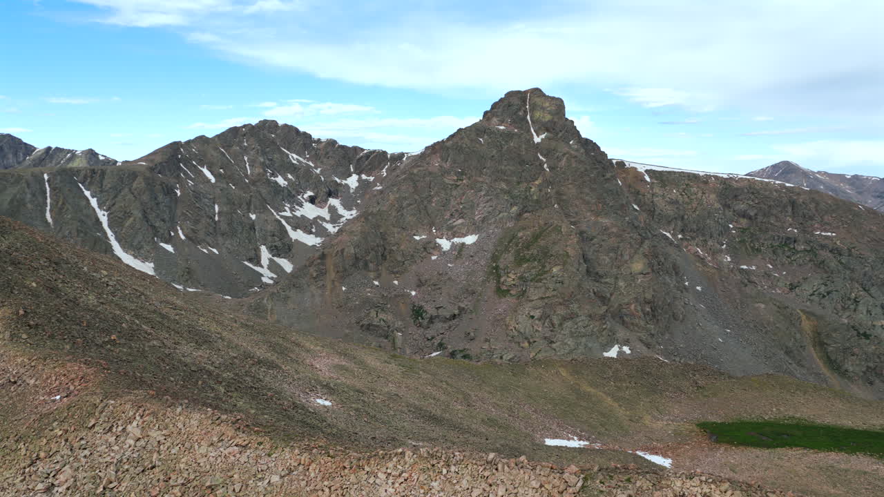 Mount of the Holy Cross 14er prominent peak wilderness landscape view aerial drone Colorado morning clouds North Mountain Shelter Halo Ridge Bowl alpine tundra snow melt Rocky Mountains circle right