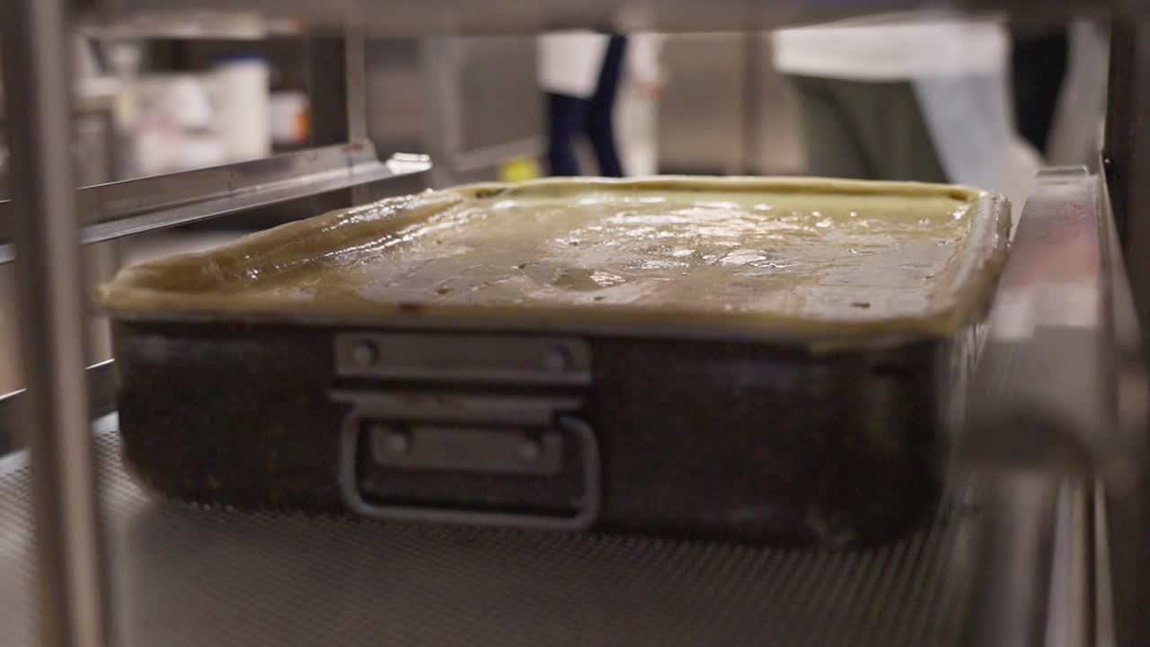Tray of flódni being placed into the oven
