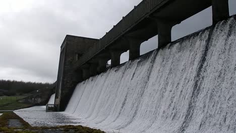 llyn cefni reservoir concrete generator gate overflowing from llangefni lagoon in anglesey, north wales, close up