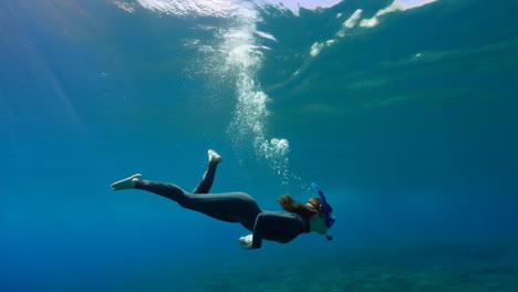 a woman snorkeling underwater
