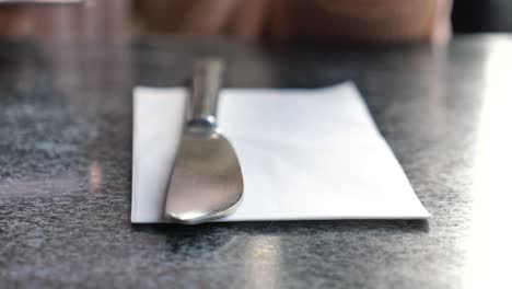 close-up of a knife and fork on a white napkin