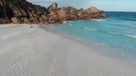 Aerial-view-of-the-white-beaches-and-turquoise-waters-at-Anse-Coco,-Petit-Anse-and-Grand-Anse-on-La-Digue,-an-island-of-the-Seychelles