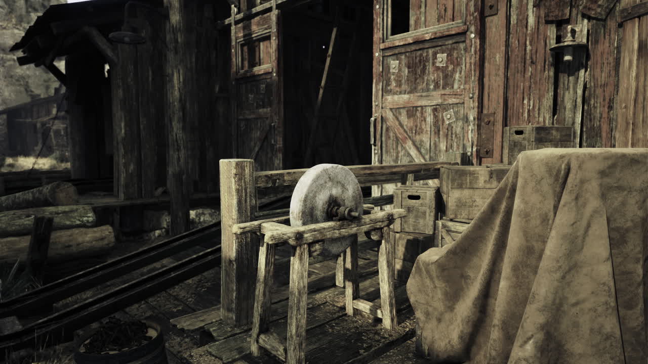 Old wooden structure with a stone wheel in a rustic setting