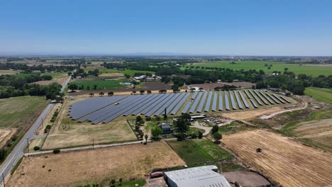 a solar farm in a rural area shot from the air with a drone.
